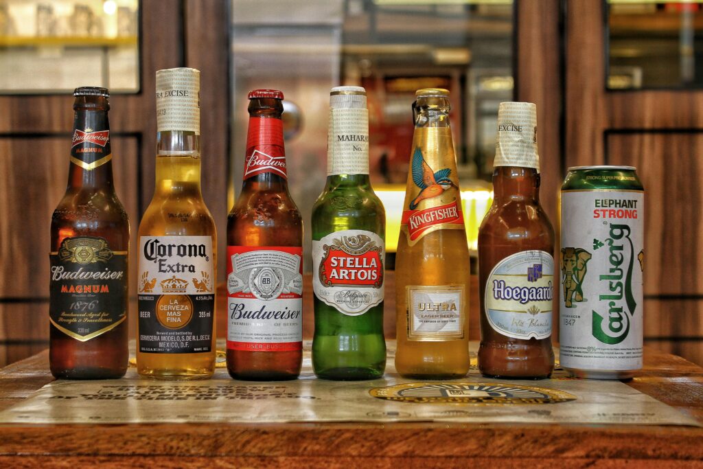 Collection of international beer bottles displayed on a bar counter.